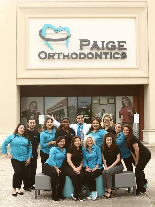 Paige Orthodontics Team poses in front of Paige Orthodontics Office in Kingwood, TX