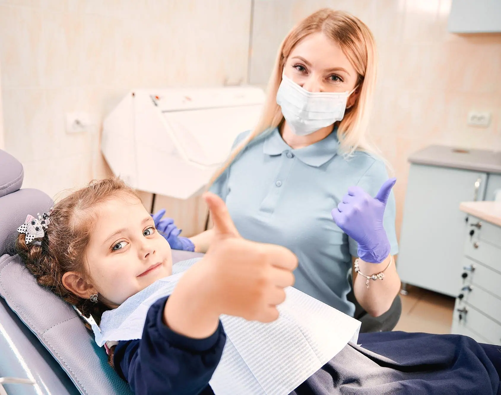 a child and a dental give a thumbs-up for Paige Orthodontics as Children’s Orthodontist best in Kingwood, TX
