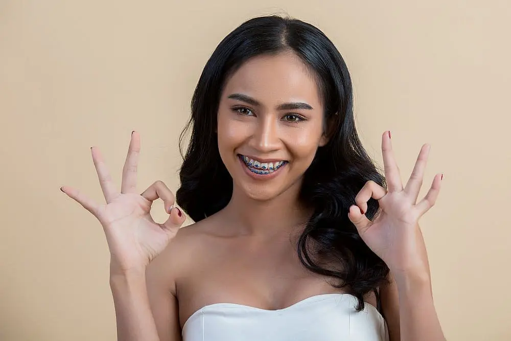 Beautiful woman face with metal braces from Paige Orthodontics best in Kingwood, TX