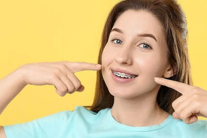 Best Orthodontics Close-up of an adult receiving new braces during their orthodontic treatment at Paige Orthodontics in Kingwood, TX.