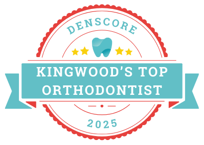 A badge featuring the text "Denscore," three stars, a tooth icon, and "Kingwood TX's Top Orthodontist 2025.